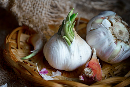 garlic in a basket on a wooden background. tinting. selective focusの写真素材