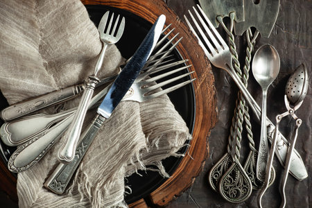 Vintage cutlery and kitchen utensils on wooden background