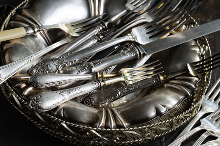 Vintage silverware in a metal bowl. Selective focus.の写真素材