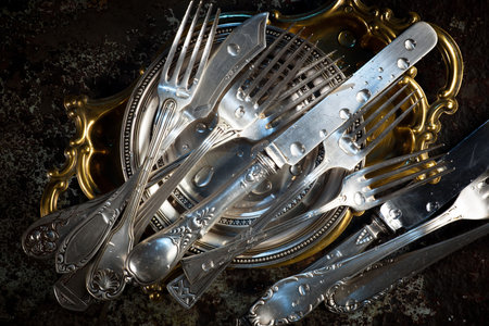 Vintage silverware on a dark background. Selective focus.