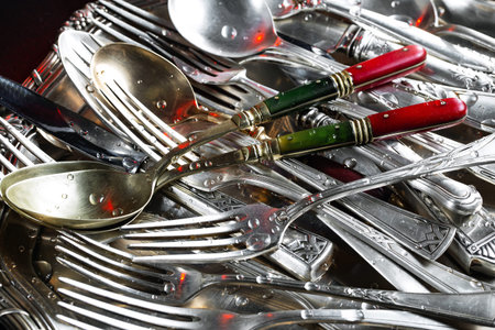 Vintage silver cutlery on a dark background. Selective focus.