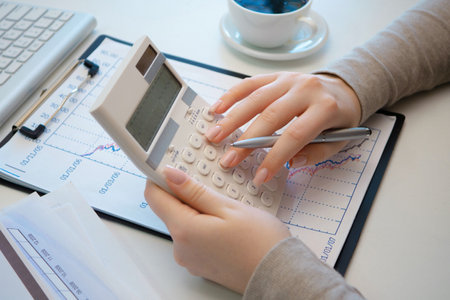 Close up of businesswoman hand using calculator and making calculations. Accountingの写真素材