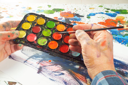 Painter paints a picture on a canvas with watercolors.の写真素材