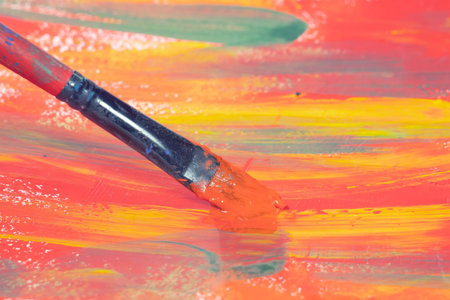 Paintbrush and palette of colors on a white background closeup