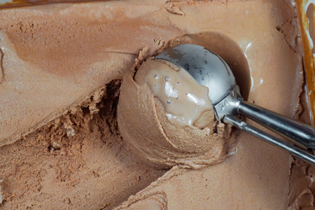 chocolate ice cream with scoop on the table, close-upの写真素材