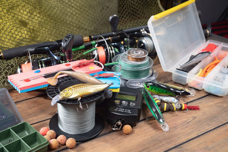 Fishing tackle on a wooden table. Accessories for fishing. Toning.の写真素材