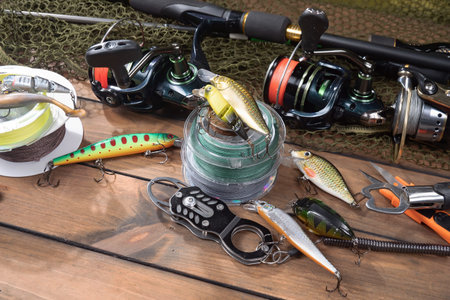 fishing tackle on a wooden table, close-up, horizontal