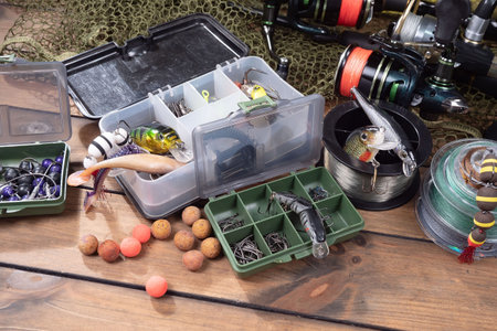 Fishing tackle on a wooden table. Accessories for catching fish.