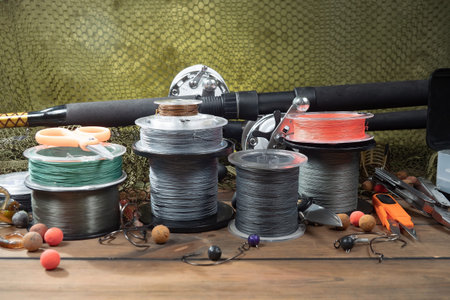 Fishing tackle on a wooden table. Fishing tackle on a wooden table.
