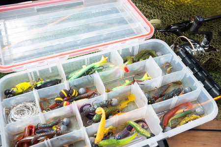 Fishing tackle in plastic box. Bait for fishing, hooks, lures.の写真素材