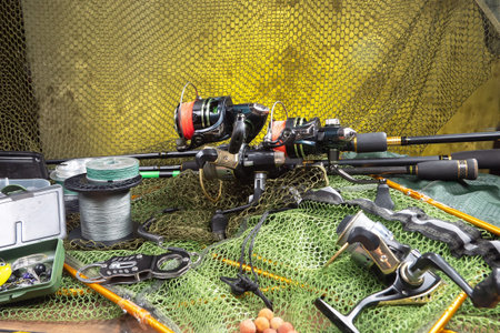 Fishing rods and spinnings on the background of fishing nets