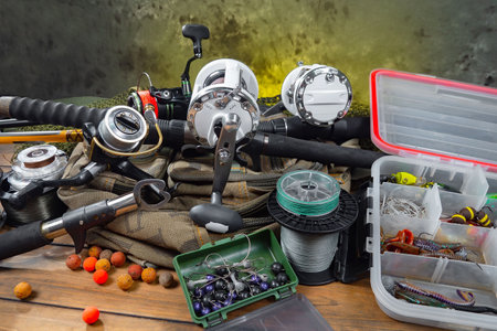 Fishing tackle on a wooden table in the workshop. Fishing tackle.の写真素材