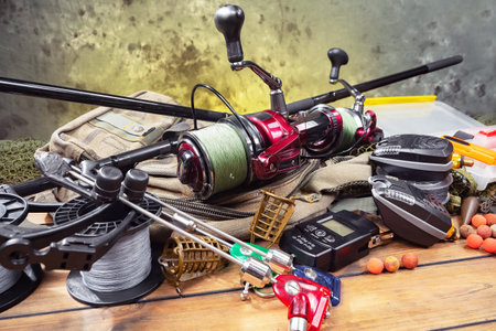 Fishing tackle on a wooden table. Fishing rods, reel, spinnings and other accessories for fishing.の写真素材