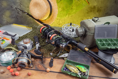 Fishing tackle on a wooden table. Accessories for fishing on a wooden background.