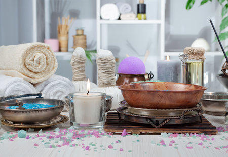 Spa and wellness setting with candles and towels on wooden table.の写真素材