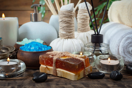 Spa still life with soap, sea salt and candles on wooden backgroundの写真素材