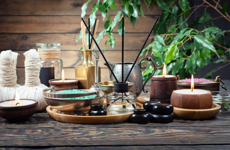 Spa still life with aroma sticks, stones and candles on wooden backgroundの写真素材