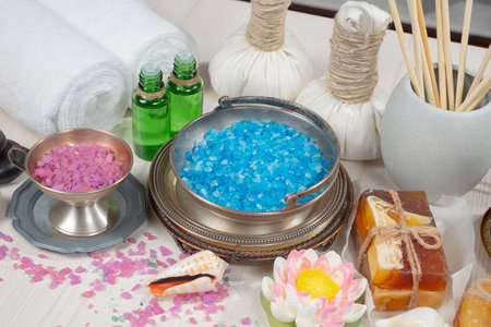 Spa and wellness setting with blue sea salt, aroma oil and towelの写真素材