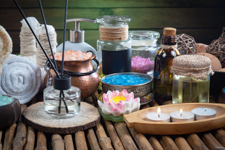 Spa still life with aromatic oils, candles and flowers on wooden backgroundの写真素材