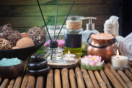 Spa still life with aromatic oils and candles on a bamboo backgroundの写真素材