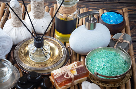 Spa and wellness setting with essential oils, soap, sea salt and towelsの写真素材