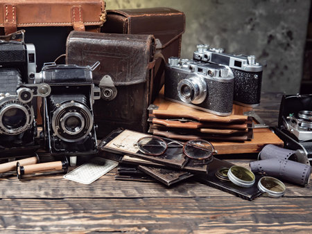 Vintage camera and travel accessories on a wooden background. Selective focus.