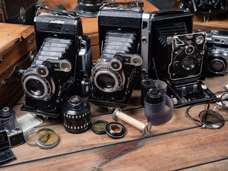 Vintage camera on a wooden table. Photo in old color image style