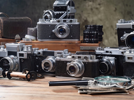 Vintage camera on a wooden table with other vintage objects in the background