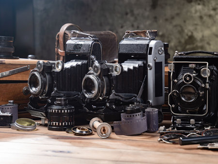 Old camera on a wooden table in a photo studio. Vintage styleの写真素材
