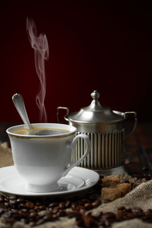 Coffee in a cup and saucer on a dark backgroundの写真素材