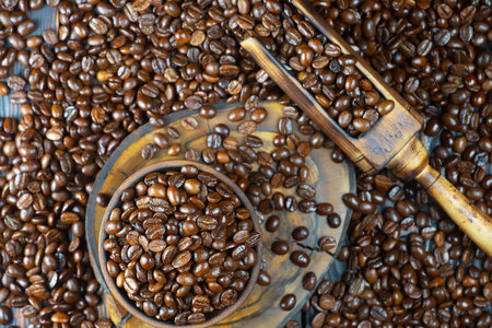 Coffee beans in a wooden bowl and scoop on a blue backgroundの写真素材