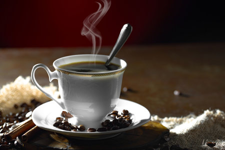 Coffee in a cup and saucer on a dark backgroundの写真素材