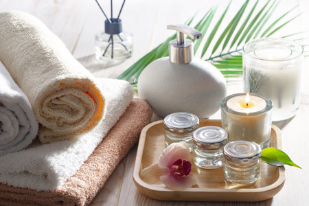 Spa and wellness setting with towels, candles and orchidsの写真素材