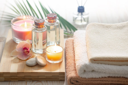 Spa still life with towels, candles and orchid on light backgroundの写真素材