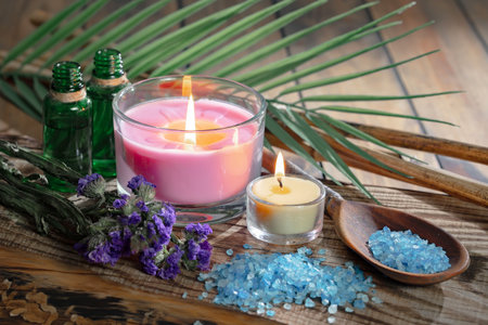 Spa still life with sea salt, candles and flowers on wooden backgroundの写真素材