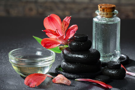 Spa still life with red lily flower and zen stonesの写真素材