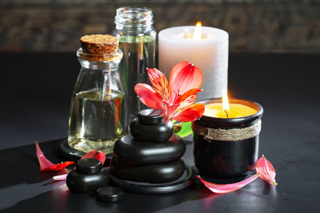 Spa still life with candles, zen stones and red flowersの写真素材