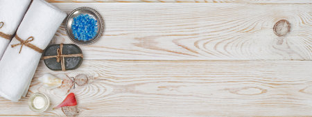 Spa and wellness setting. Towels, candles, sea salt on wooden backgroundの写真素材