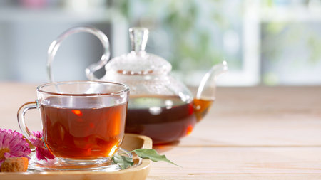 tea in glass cup and teapot on the wooden tableの写真素材