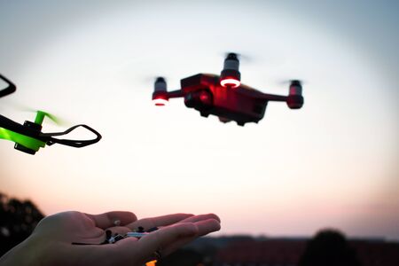 A man is going to feed the drone. The future has come. Drones baitmetal parts.の写真素材