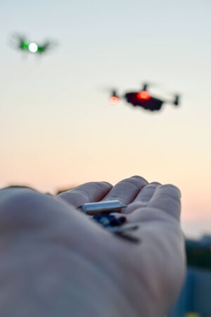 A man is going to feed the drone. The future has come. Drones baitmetal parts.の写真素材