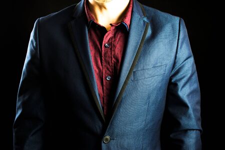 Businessman in a suit and red shirt.の写真素材