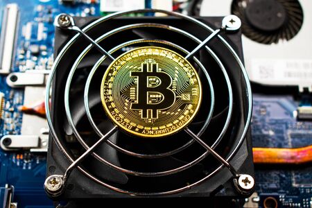 Bitcoin coin is on a computer cooler.の写真素材