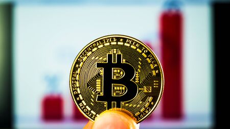 Bitcoin on the background of a growing red graph.の写真素材