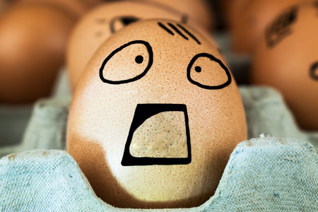 Emotional chicken eggs in a tray. Interesting grimace on eggs.