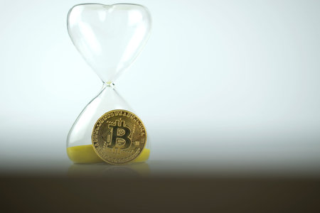 Bitcoin coin with an hourglass. The rapid growth of the cryptocurrency
