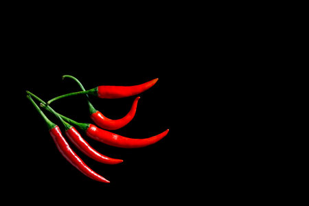 chilli on black background, isolatedの写真素材
