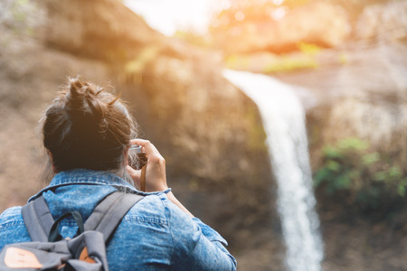Women are shooting a waterfall.の写真素材