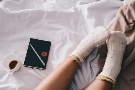 Women wear socks And coffee on the couchの写真素材
