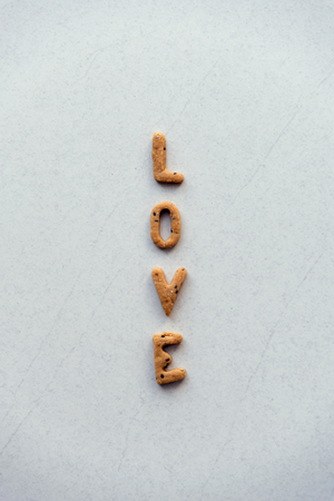 The word "LOVE" made from cracker on white backgroundの写真素材
